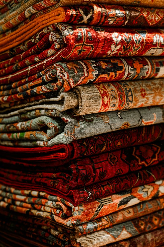 About A colorful assortment of Persian rugs showcasing intricate designs and rich textures, perfect for interior decor.
